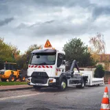 A 12-tonne / 14-tonne Renault Trucks D fitted with a Hiab crane on a roadworks site in town