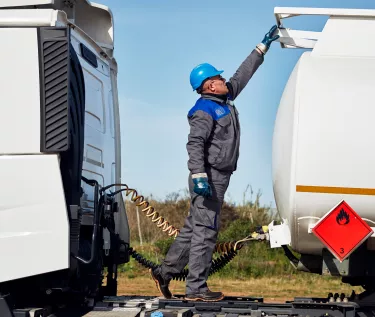 Driver checking a tanker attached to a Renault Trucks tractor